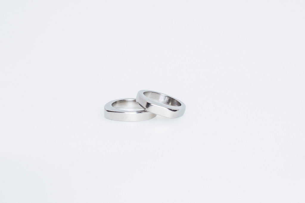 6. Flat lay of Lentsius Twins rings in stainless steel, highlighting sleek finish