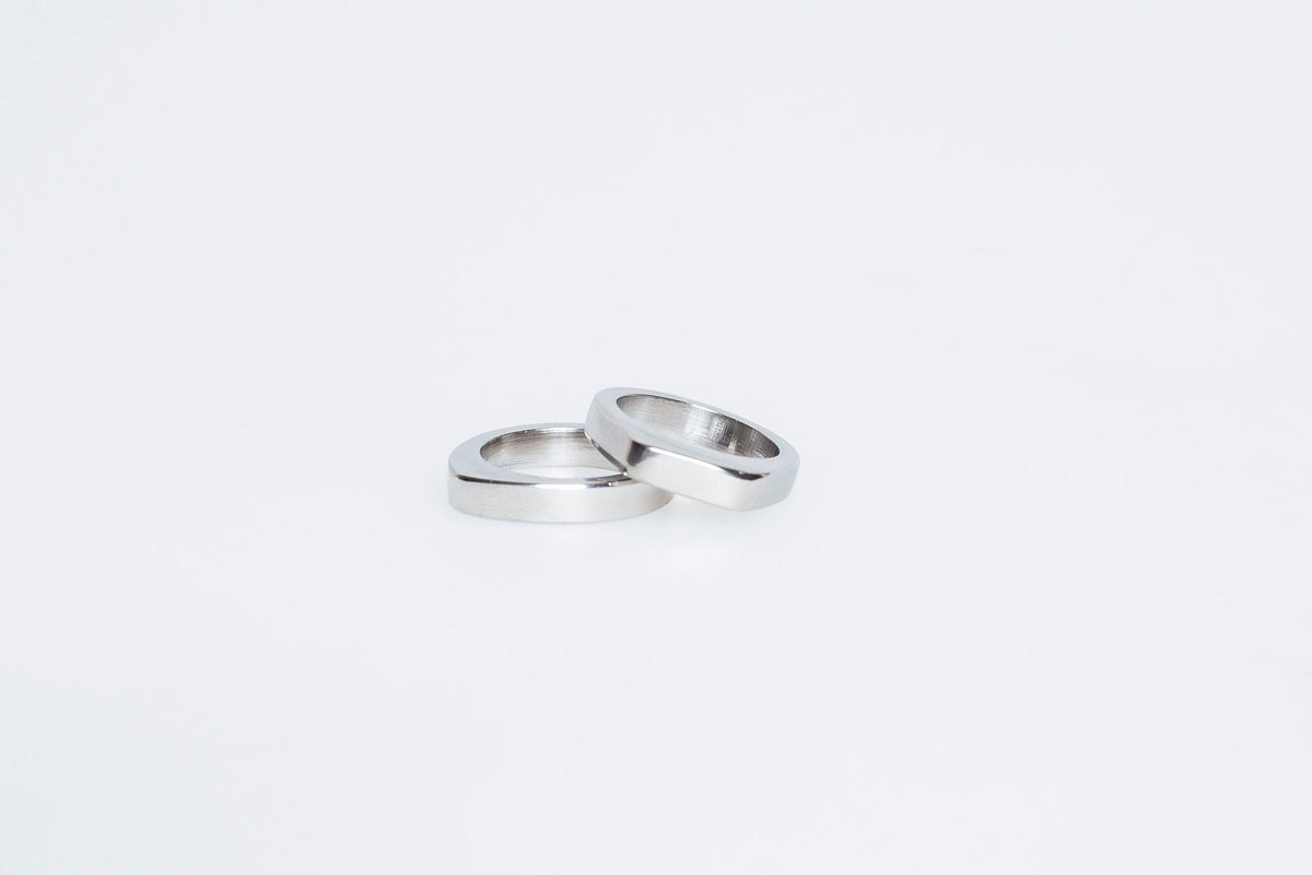 6. Flat lay of Lentsius Twins rings in stainless steel, highlighting sleek finish