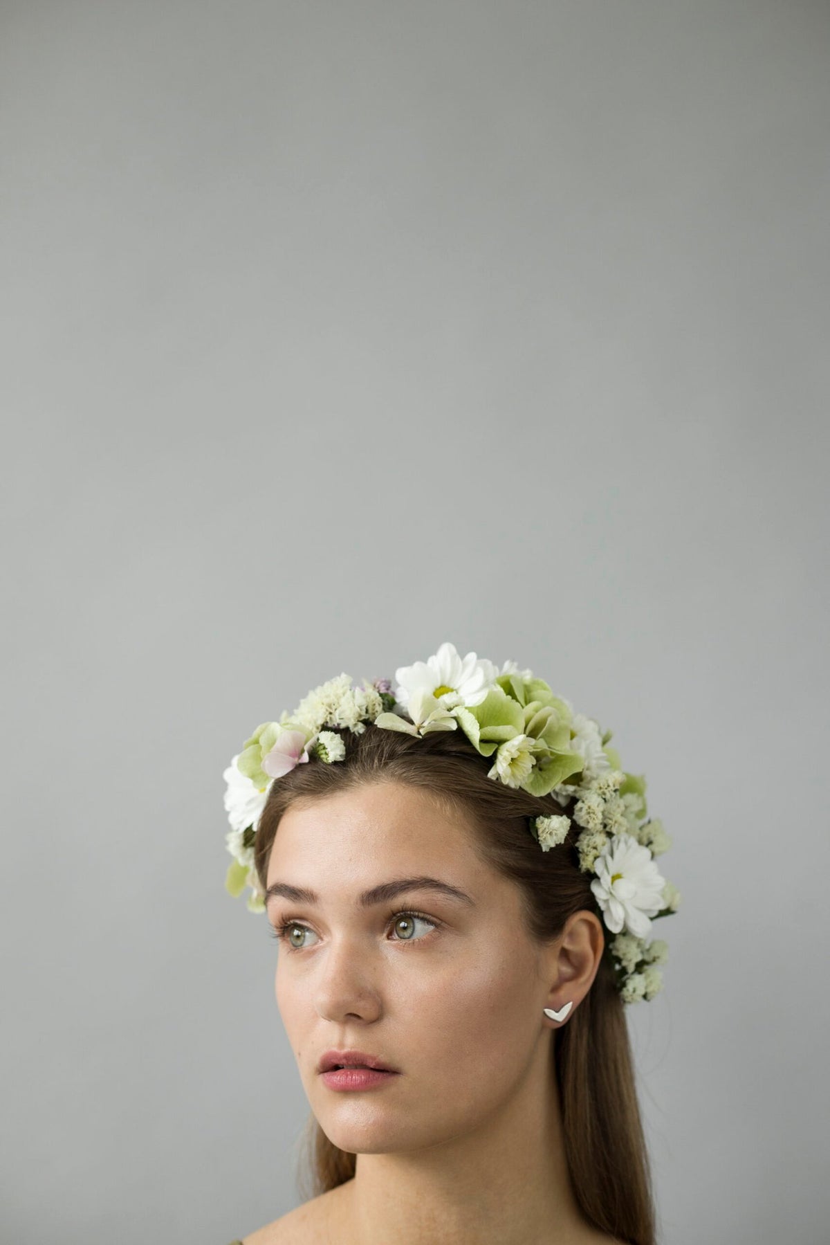 2. Woman with floral headpiece wearing Lentsius Vola silver earrings, highlighting elegant design