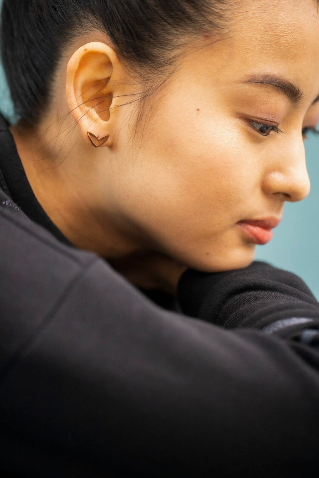 7. Close-up of woman wearing Lentsius Vola rose gold earrings, highlighting hypoallergenic material