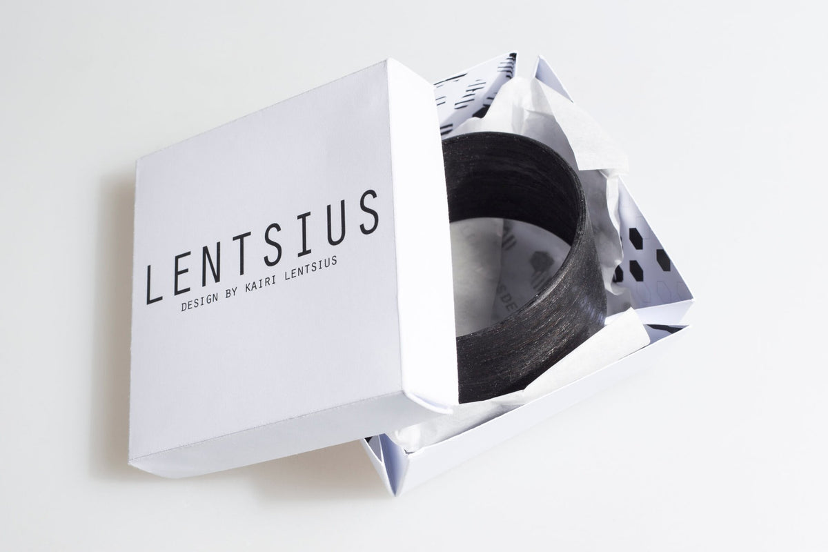 2. Lentsius Woody black pine bracelet in branded packaging, highlighting eco-conscious fashion