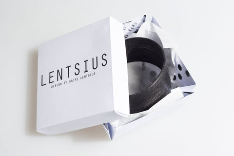 2. Lentsius Woody black pine bracelet in branded packaging, highlighting eco-conscious fashion