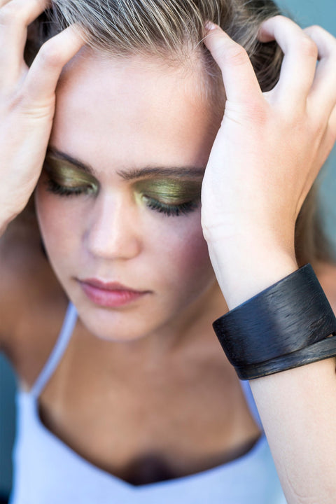 1. Woman wearing Lentsius Woody black pine bracelet, showcasing Scandinavian style and sustainable design