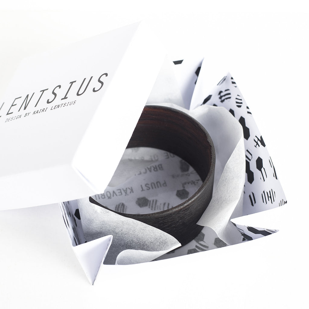 2. Lentsius Woody Bracelet in Ebony displayed in branded packaging with geometric design