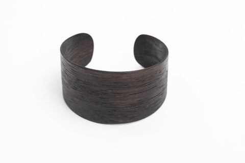 1. Lentsius Woody Bracelet in Ebony, handmade from natural ebony veneer, shown in studio setting