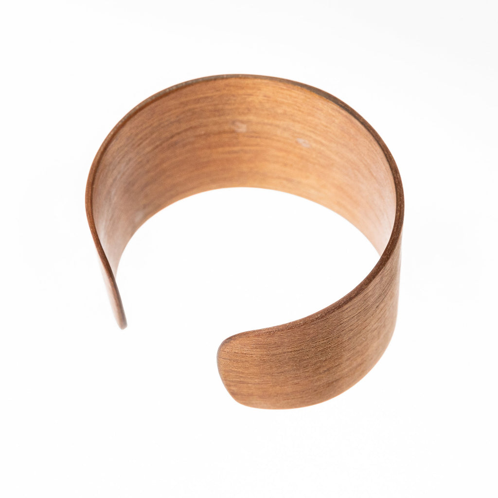2. Side view of Lentsius Woody Bracelet in Thermo Birch, highlighting upcycled wood material, studio setting