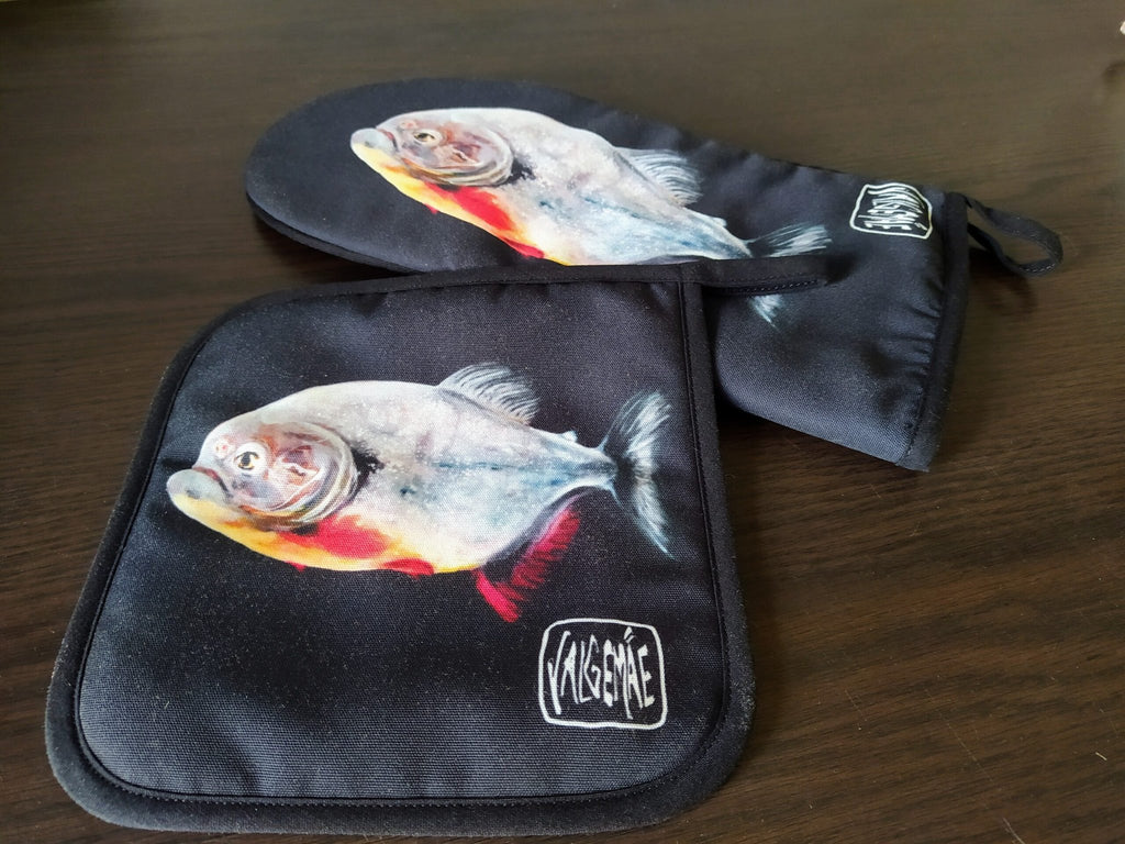 2. Set of black oven mitt and potholder with fish painting, featuring Katrin Valgemäe logo, on wooden surface