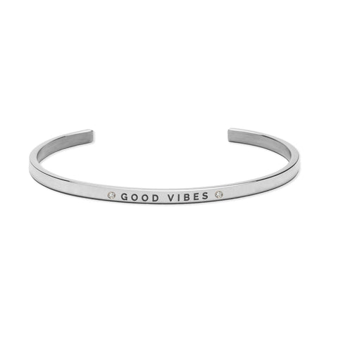 3. Silver 'Good Vibes' bracelet by Olla, made from polished stainless steel with engraved text and crystal embellishments, shown in studio