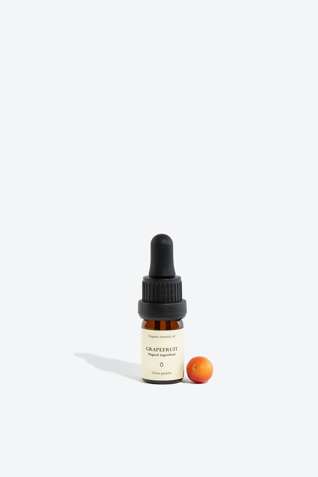 2. Smells Like Spells Grapefruit Essential Oil with small grapefruit, 5 ml glass bottle, studio setting