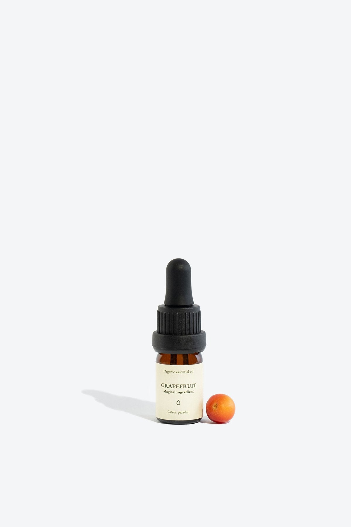 2. Smells Like Spells Grapefruit Essential Oil with small grapefruit, 5 ml glass bottle, studio setting