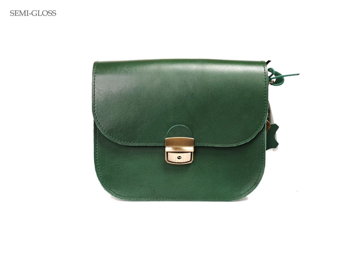4. Front view of Zelma Kraft green leather saddle bag with semi-gloss finish and buckle closure