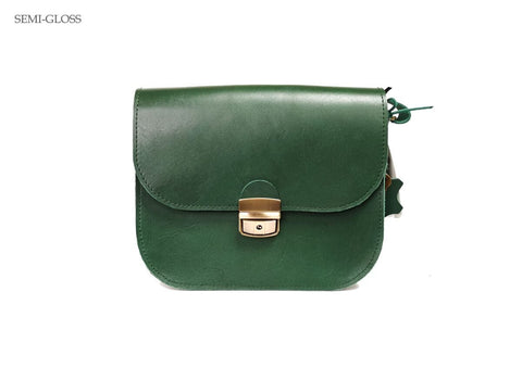 4. Front view of Zelma Kraft green leather saddle bag with semi-gloss finish and buckle closure