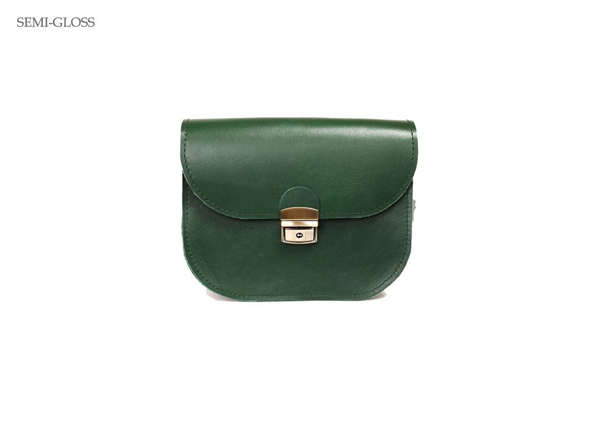 4. Zelma Kraft green leather saddle bag in semi-gloss finish, studio setting