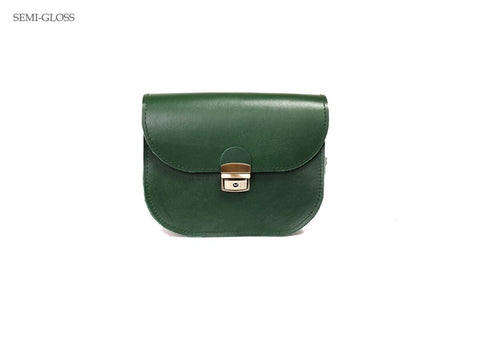 4. Zelma Kraft green leather saddle bag in semi-gloss finish, studio setting