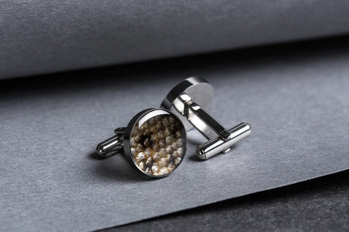2. Pair of Eherüs round cufflinks with black-spotted leather on grey background