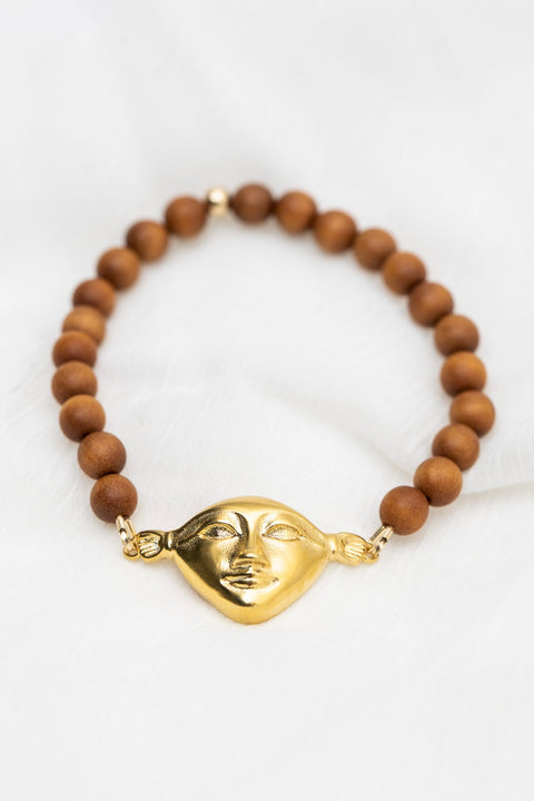 3. Hathor Harmony Bracelet in sandalwood with gold plated silver face, styled on white fabric
