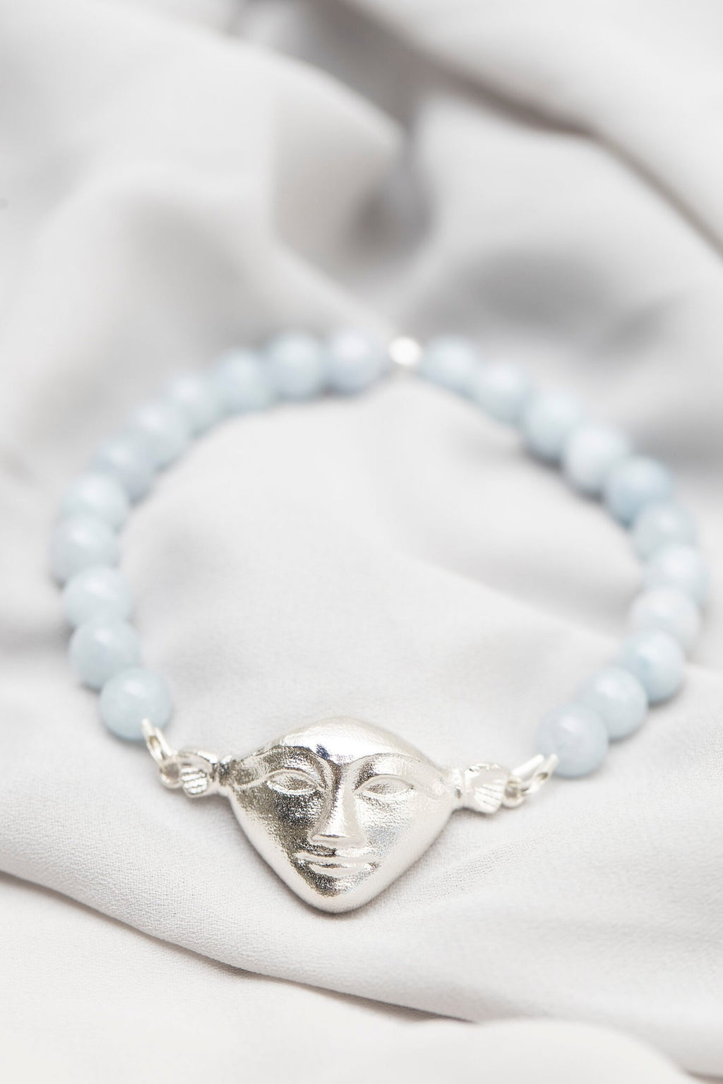 2. Close-up of Hathor Harmony Bracelet in aquamarine and silver by New Vintage by Kriss on a soft fabric background