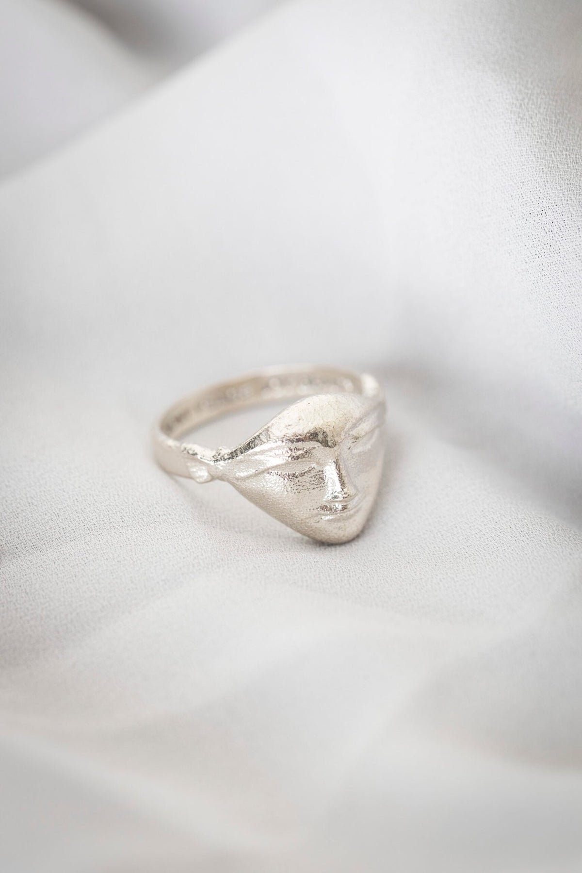 3. Studio shot of Hathor Harmony Ring in silver on white fabric, by New Vintage by Kriss