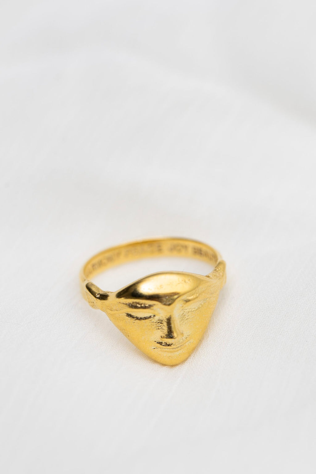 3. Hathor Harmony Ring in gold by New Vintage by Kriss, shown on white fabric background