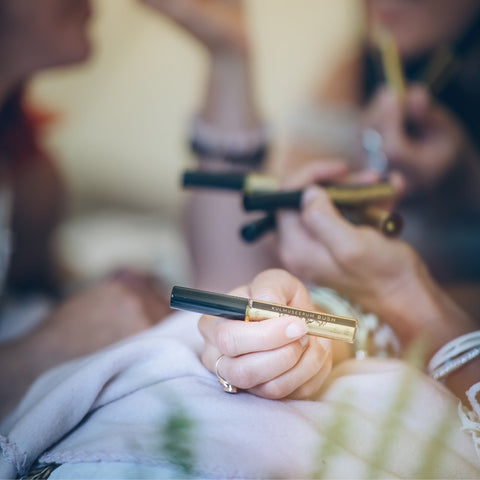 1. Women holding HOIA homespa Brow Serum in a lifestyle setting, showcasing product use and packaging