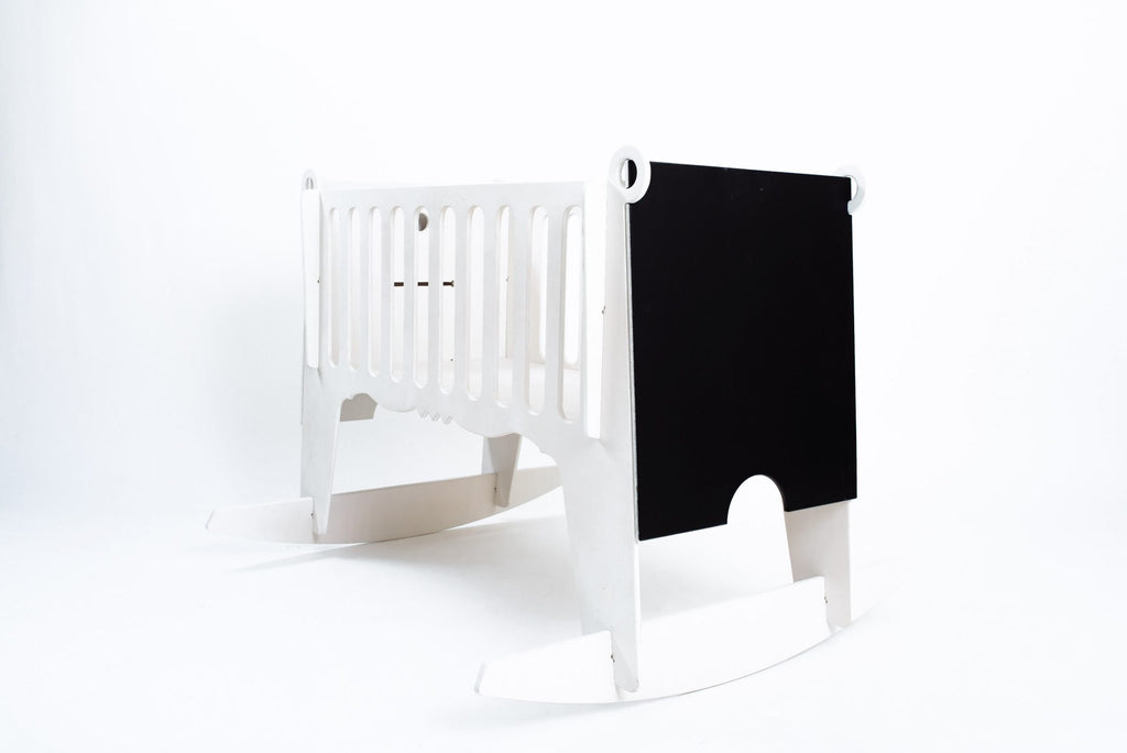 3. Side view of white Adensen birchwood cradle with blackboard end panel on white background