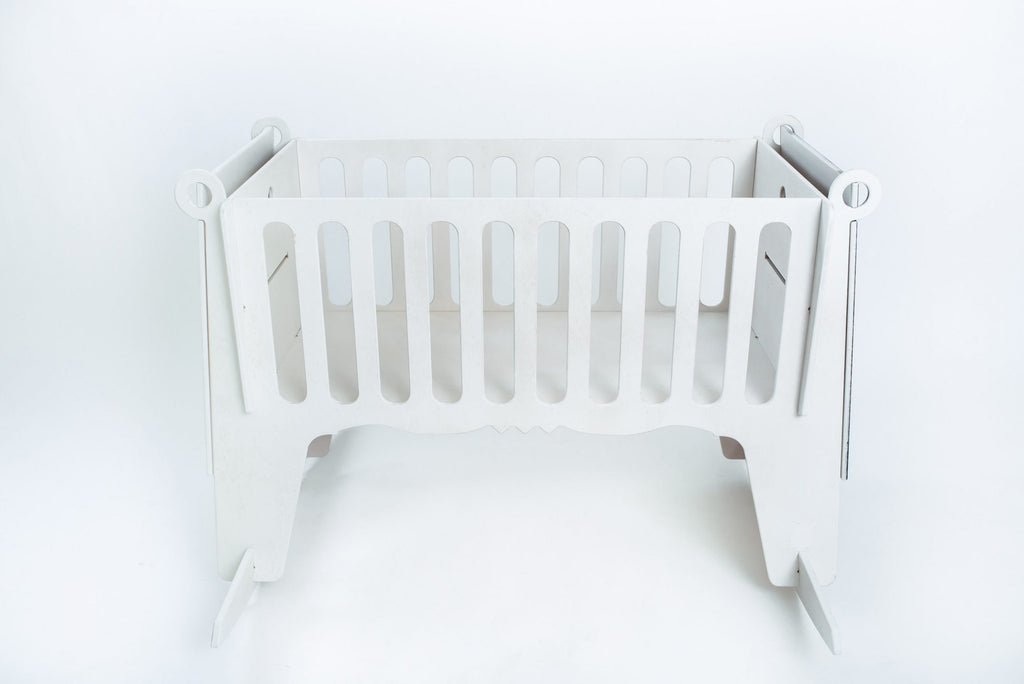 2. White Adensen birchwood baby cradle with slatted sides on white background