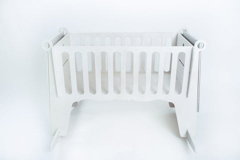 2. White Adensen birchwood baby cradle with slatted sides on white background