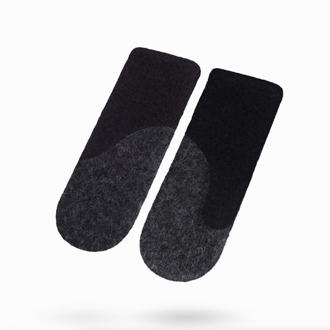 1. Studio shot of HERTTA felted wool mittens in black and dark grey, showcasing the warm and stylish design for winter wear