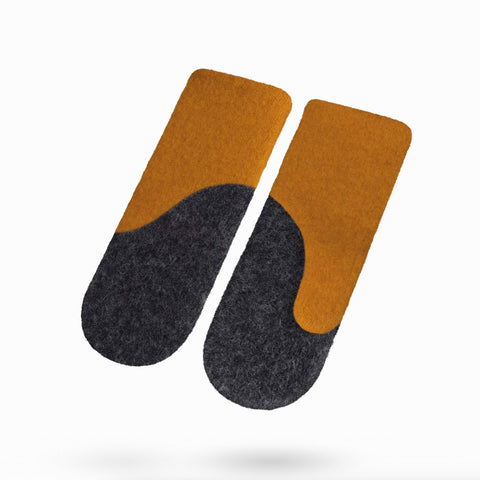 1. Women's felted wool mittens in curcuma and dark grey by HERTTA, shown in studio setting