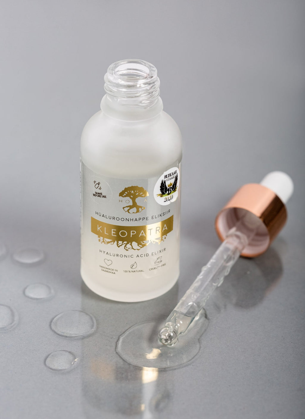 3. Close-up of HOIA homespa Hyaluronic Acid Elixir Kleopatra with open dropper and liquid drops