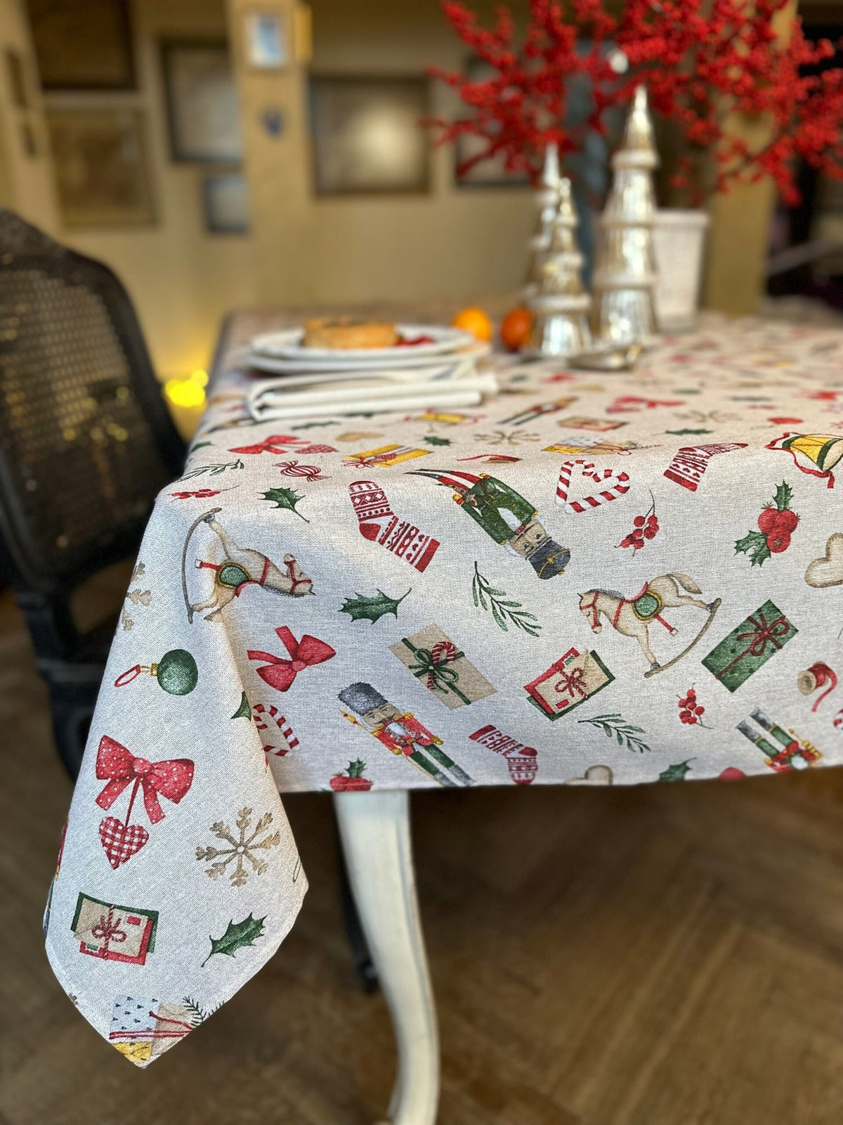 2. Hortensias Home Christmas Story tablecloth with festive design, draped over dining table with holiday decor