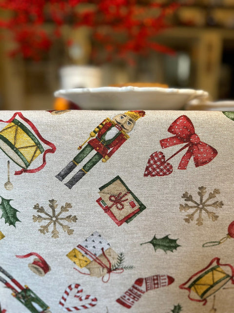 2. Close-up of Christmas Story Table Runner showing festive patterns including nutcracker, bows, and holly
