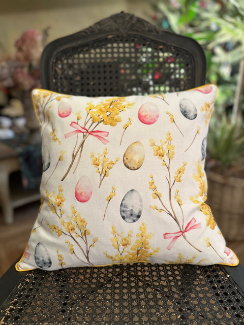 1. Hortensias Home Easter Happy pillowcase on chair, featuring playful Easter egg and floral design in yellow and pink on 100% cotton fabric