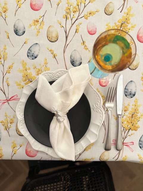 2. Close-up of Easter Happy tablecloth by Hortensias Home, showcasing colorful egg and floral design with table setting