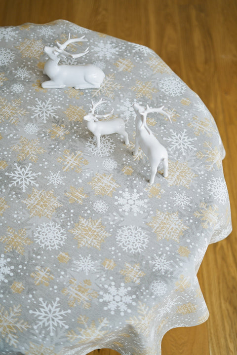 2. Top view of Hortensias Home festive snowflake tablecloth in gold and grey with reindeer decor