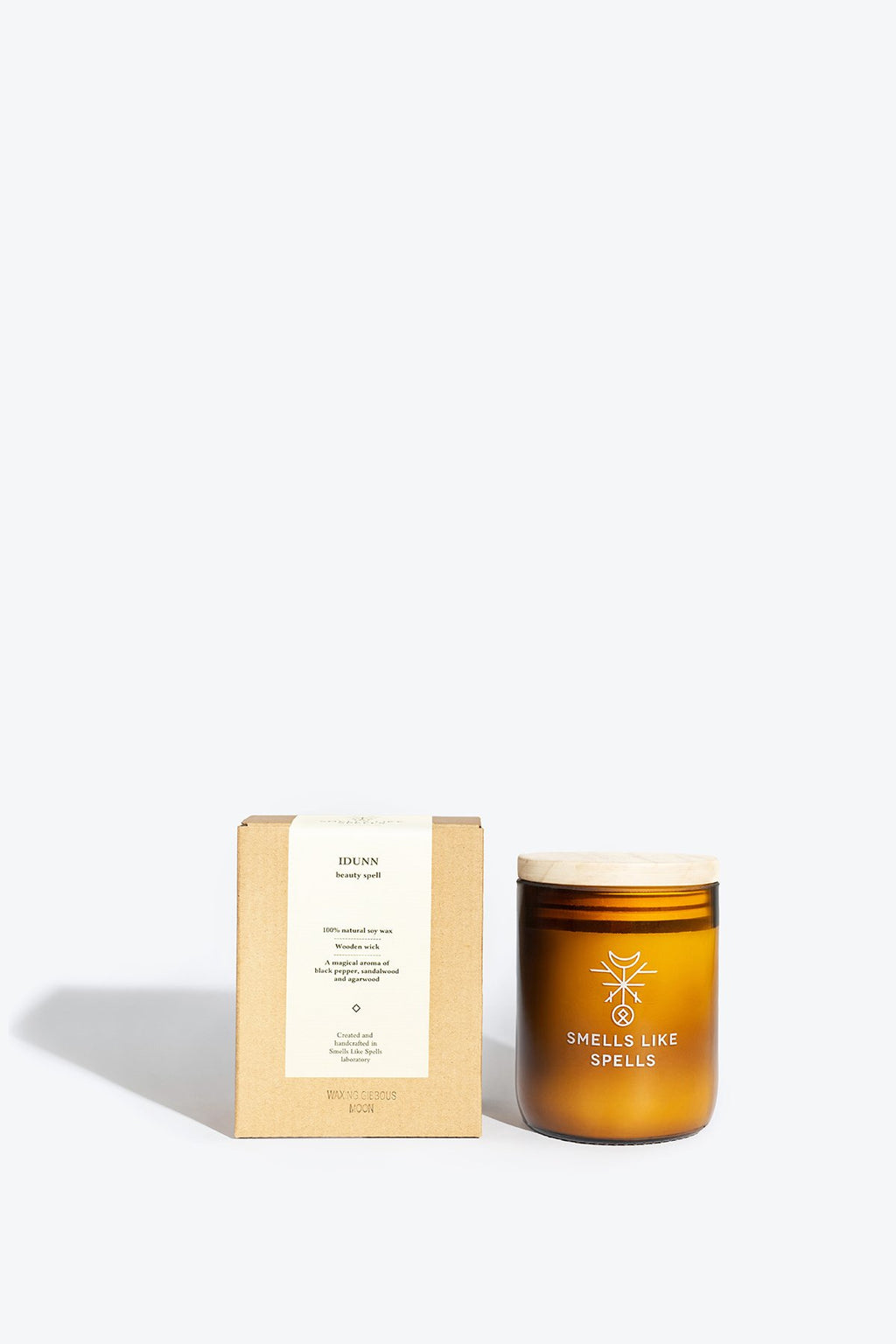 1. Smells Like Spells IDUNN scented candle in amber glass jar with packaging, showcasing handcrafted design