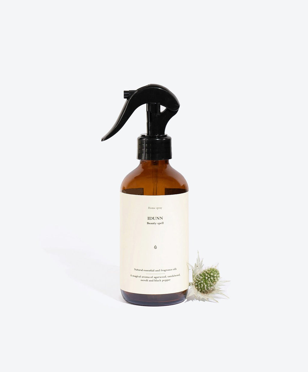 1. Smells Like Spells IDUNN perfumed home spray in amber bottle with floral accent, studio setting