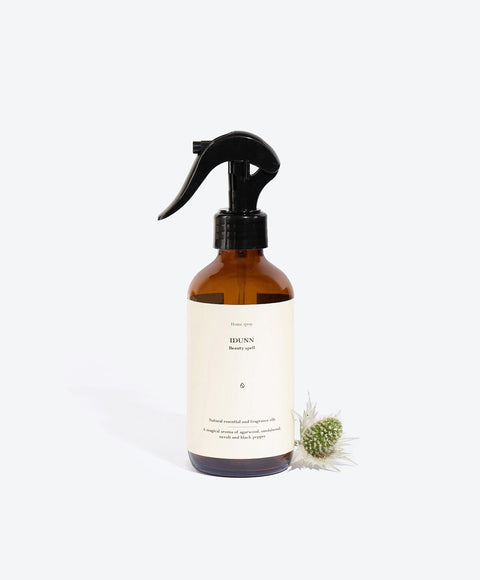 1. Smells Like Spells IDUNN perfumed home spray in amber bottle with floral accent, studio setting