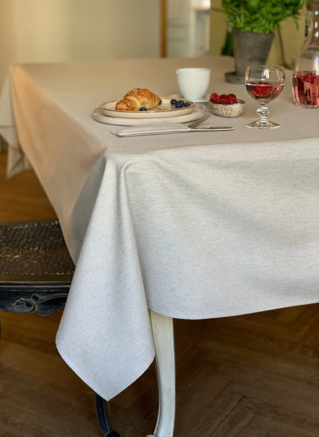 4. Lifestyle image of Hortensias Home Nord 3 tablecloth on dining table, featuring elegant drape and neutral tone