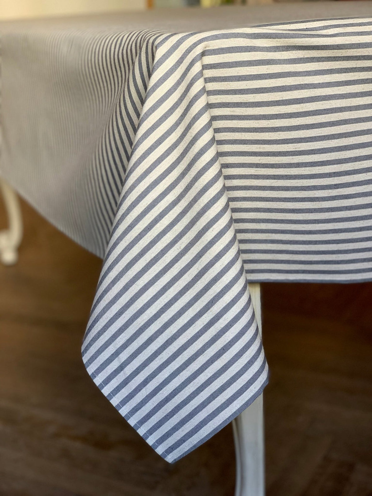 3. Close-up of blue striped rectangular tablecloth from Nord 1 Collection by Hortensias Home, showcasing fabric texture and eco-friendly design