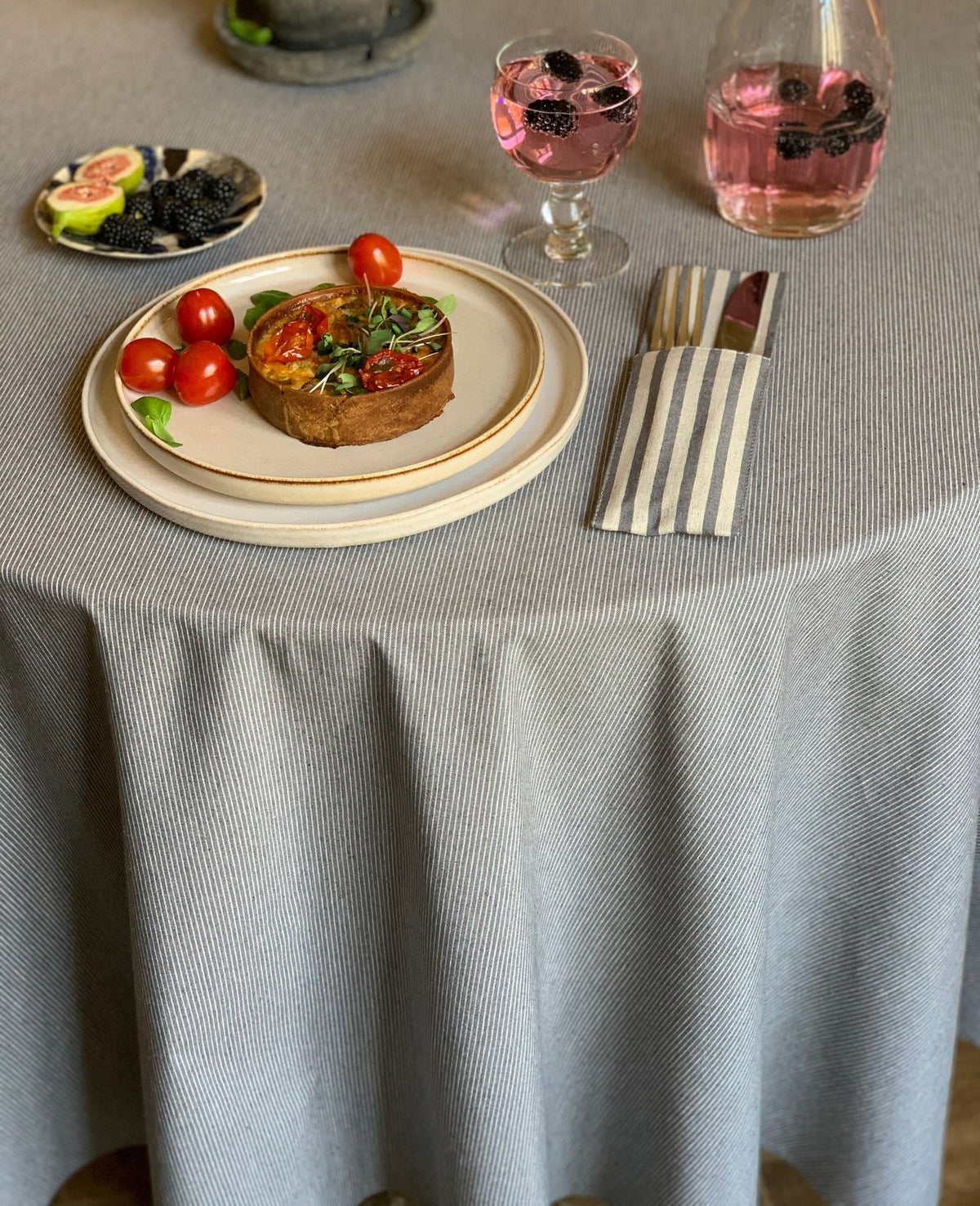 2. Close-up of Nord 2 round tablecloth by Hortensias Home, featuring Nordic-inspired design with a meal setting