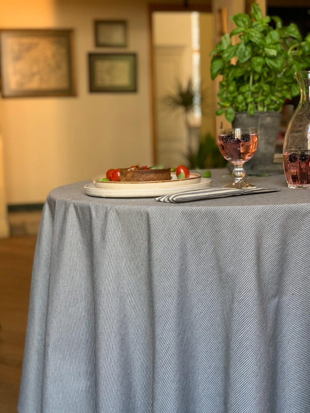 3. Side view of Nord 2 round tablecloth by Hortensias Home, showcasing eco-friendly fabric in a dining room setting