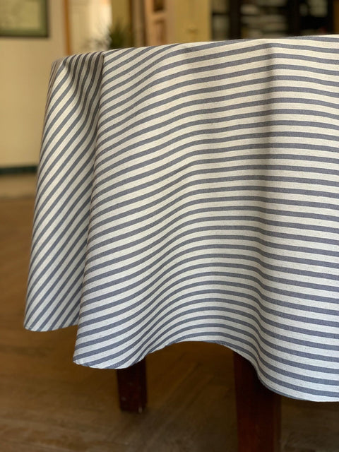 3. Studio shot of Hortensias Home round tablecloth in beige with blue lines, highlighting fabric texture and drape