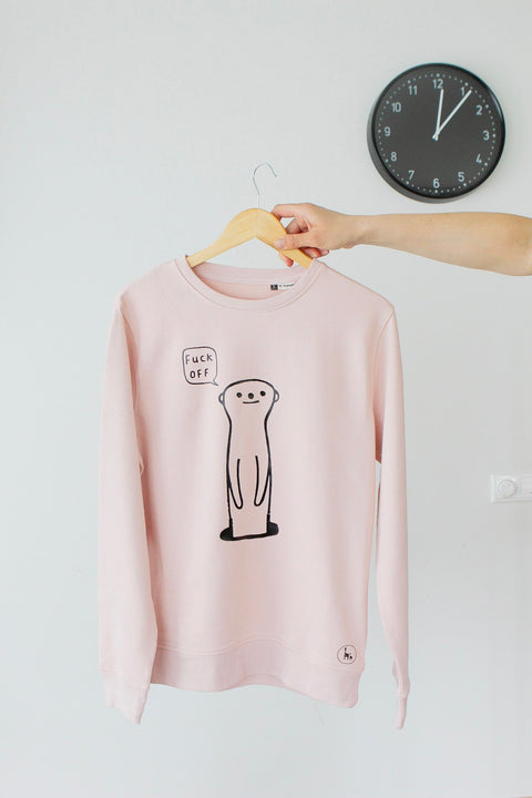 1. Unisex oversized pink sweatshirt by Black Giraffe Brand featuring a cheeky meerkat design with 'F_ck Off' text, shown on hanger in studio setting