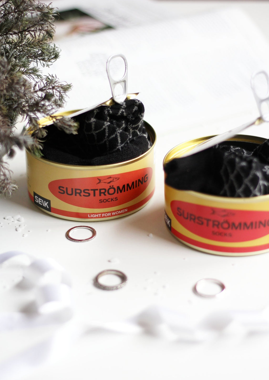2. Close-up of SEIK Surströmming socks in tin can, showcasing unique packaging and playful design for men