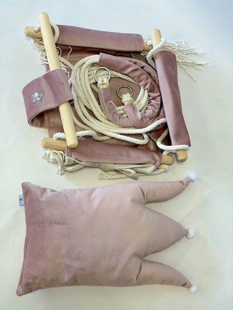 4. Flat lay of dusty pink velvet swing with crown cushion, cotton ropes, and metal rings