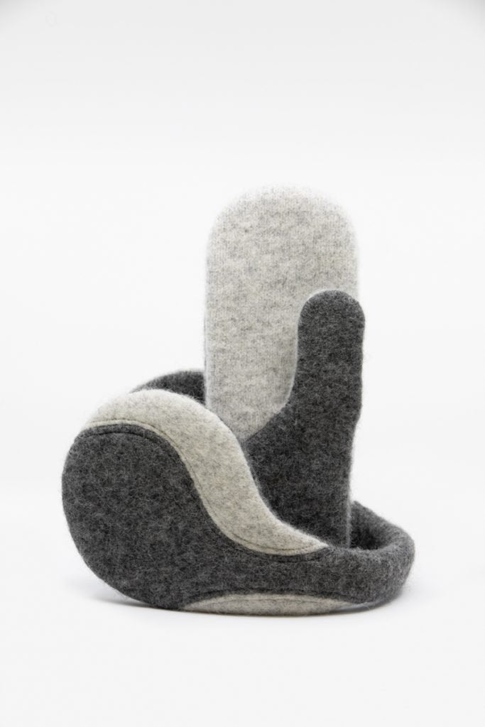 2. Studio shot of HERTTA felted wool earmuffs in medium and lightest grey, showing design and texture