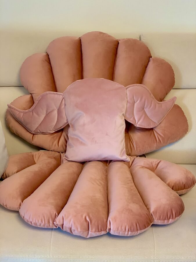 2. Handmade dusty pink velvet cushion with wing design on a matching plush background