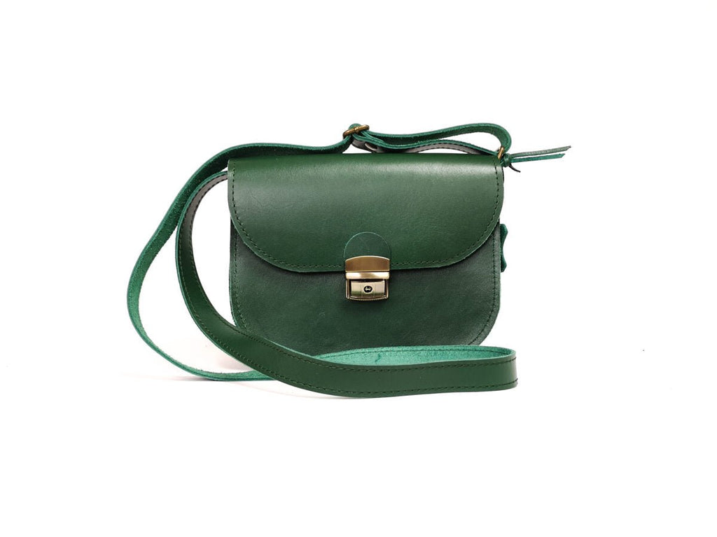 5. Side view of Zelma Kraft green leather saddle bag with adjustable strap and buckle closure