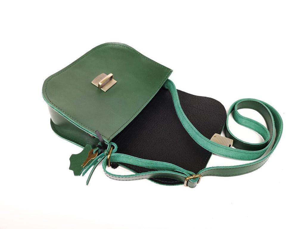 6. Open Zelma Kraft green leather saddle bag showing interior and adjustable strap